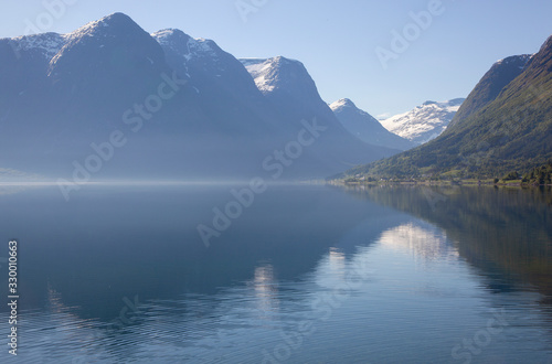 Traveling Norway along the fjords with beautiful reflections