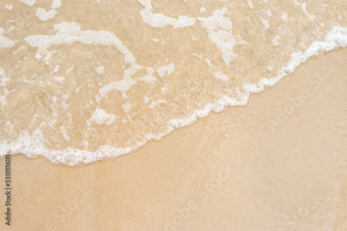 Bubble sea wave on blown sand beach sea and water reflect in blown sand background this image in background and texture concept