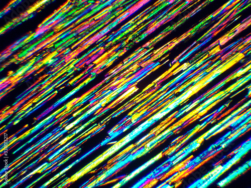 Crystal layer on microscope object glass, seen in polarized light. This causes random unforeseeable color effects.