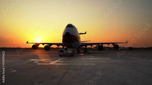 aircarft pushing back ready for departure with landing aircraft in evening