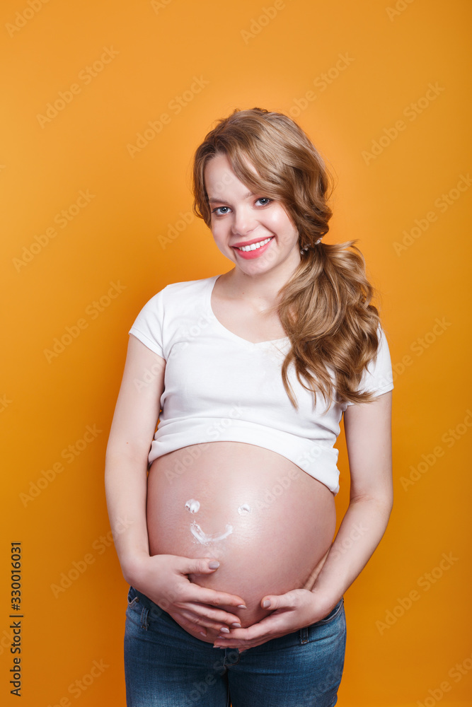 pregnant woman with smile from moisturizing cream for stretch marks pregnant woman with smile from moisturizing cream for stretch marks