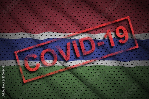 Gambia flag and red Covid-19 stamp. Coronavirus 2019-nCov outbreak photo