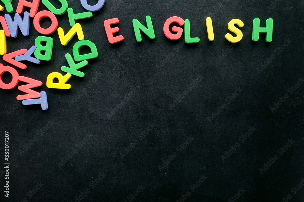 English text near letters on black background top-down copy space