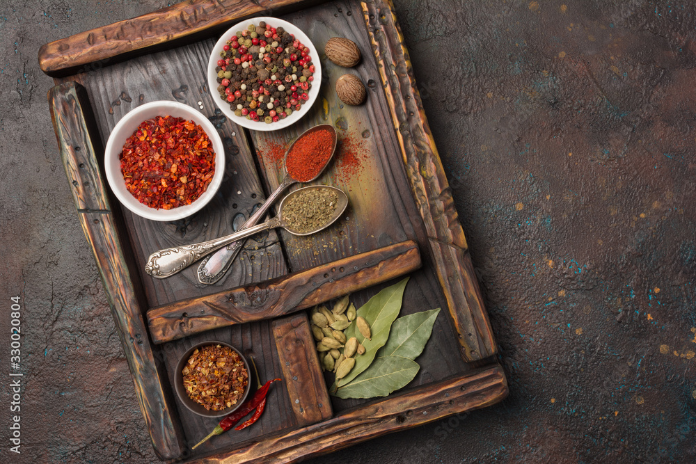 Different spices, dry kitchen herbs and seeds for tasty meals in wooden drawer Different spices, dry kitchen herbs and seeds for tasty meals in wooden drawer