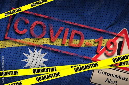 Nauru flag and Covid-19 quarantine yellow tape with red stamp. Coronavirus or 2019-nCov virus photo