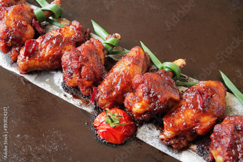  baked chicken wings with spices, tomato and soy sauce