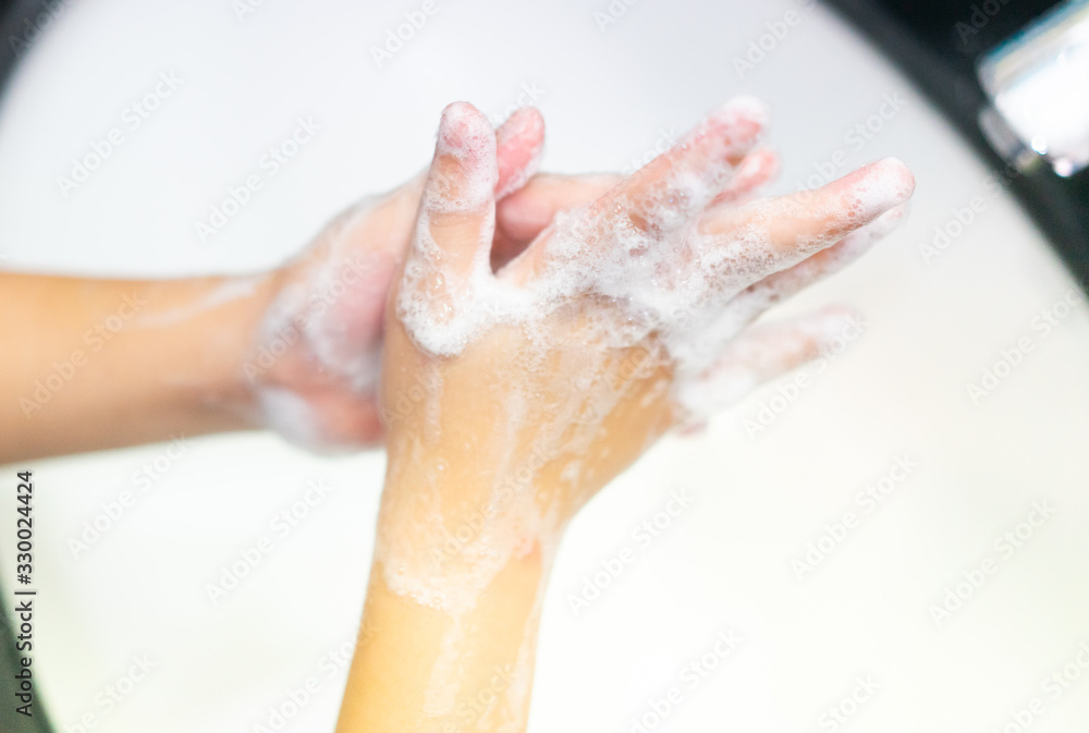 Coronavirus and Covid-19 concept.Kid girl washing hands with soap under the faucet with water in bathroom at home.Stop corona virus outbreak.Coronavirus and epidemic virus symptoms.Step by Step. Coronavirus and Covid-19 concept.Kid girl washing hands with soap under the faucet with water in bathroom at home.Stop corona virus outbreak.Coronavirus and epidemic virus symptoms.Step by Step.
