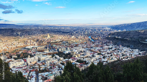Fototapeta Naklejka Na Ścianę i Meble -  TBILISI, GEORGIA  DECEMBER 14, 2019:  Beautiful aerial view of the central part of city    and blue sky in Tbilisi, Georgia