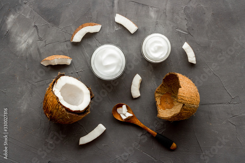 Homemade coconut cream - still life with spoon - on grey background top-down