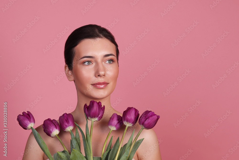 Portrait of a girl in the studio on a pink background, a girl with tulips on a pink background Portrait of a girl in the studio on a pink background, a girl with tulips on a pink background