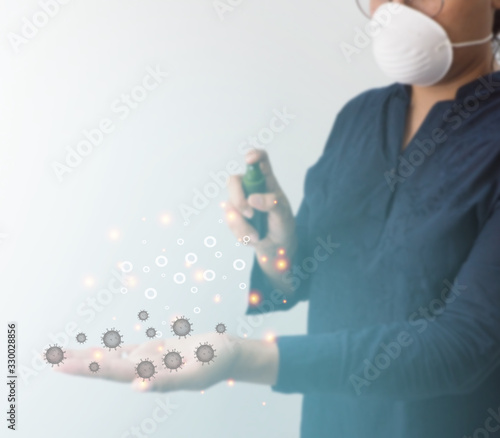 Women spraying 75 percent alcohol spray on the left hand contaminated with the virus