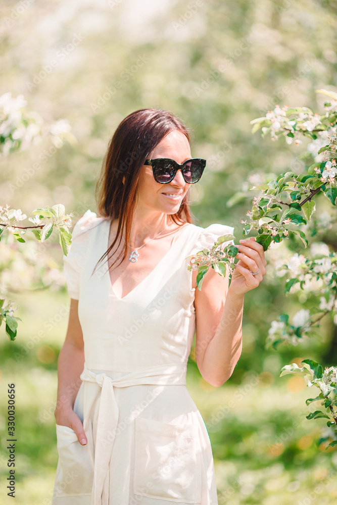 Beautiful woman enjoying smell in spring cherry garden Beautiful woman enjoying smell in spring cherry garden