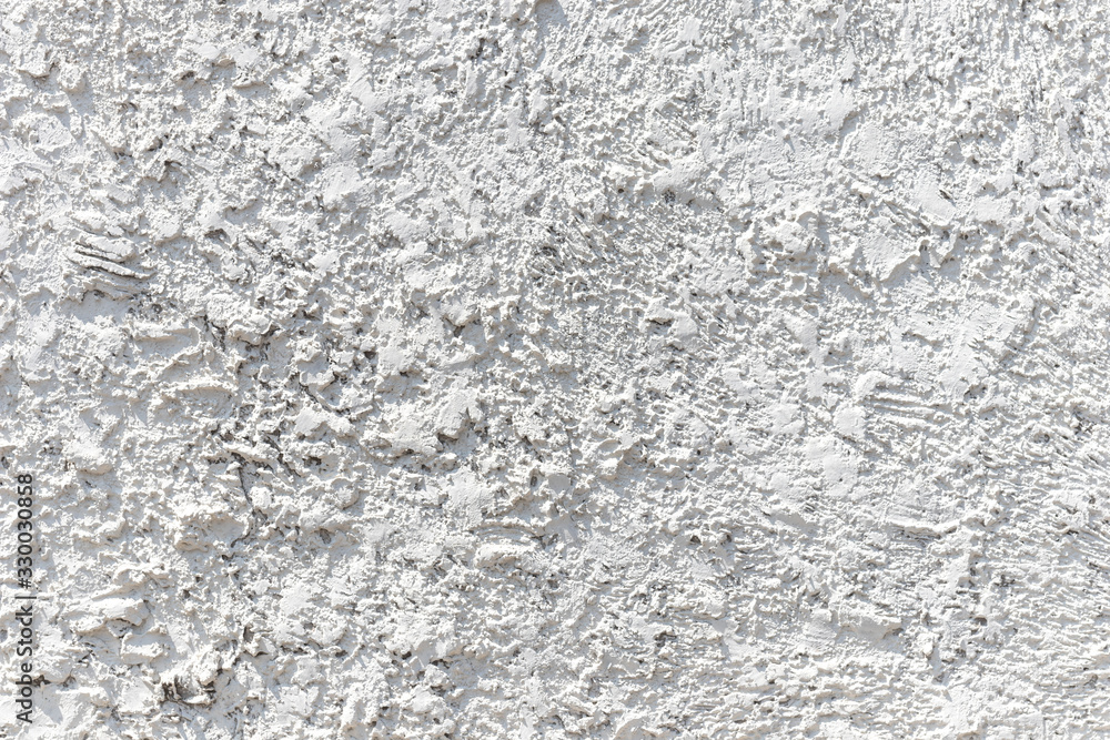 White cement wall with ragged and dirty surface texture. The old and broken rough white concrete wall background.