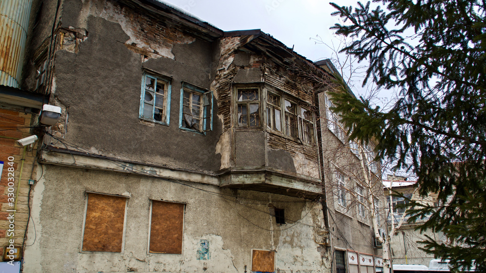 Old Erzurum houses. Historical stone bazaar and ruined wooden houses.