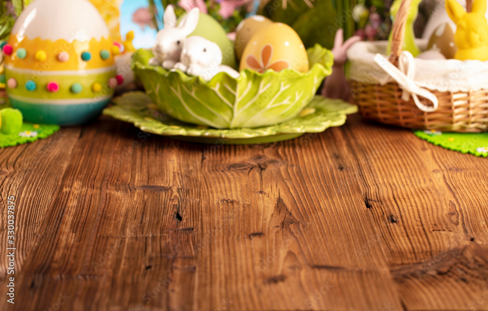 Happy Easter background. Bouquet of spring flowers. Easter decorations and Easter eggs in basket on rustic wooden table.