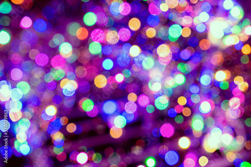Christmas background. Festive elegant abstract background with colorful bokeh lights and stars