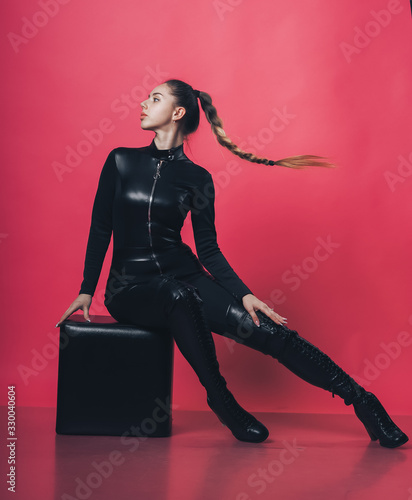 Brunette sexy girl posing at the pink background photo