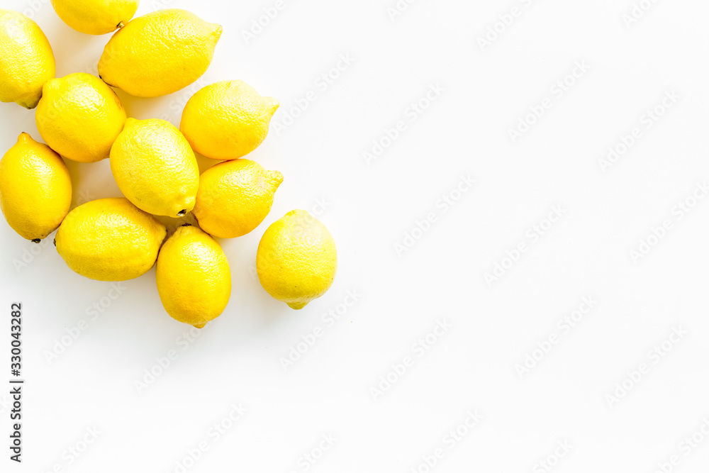 Ripe lemons - whole fruits - on white table top-down copy space Ripe lemons - whole fruits - on white table top-down copy space