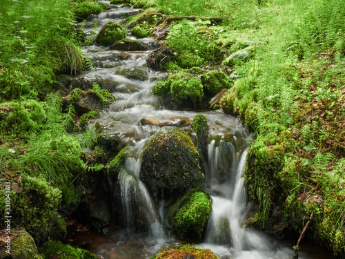 Flowing water in small creek closeup in Ylläs, Finland