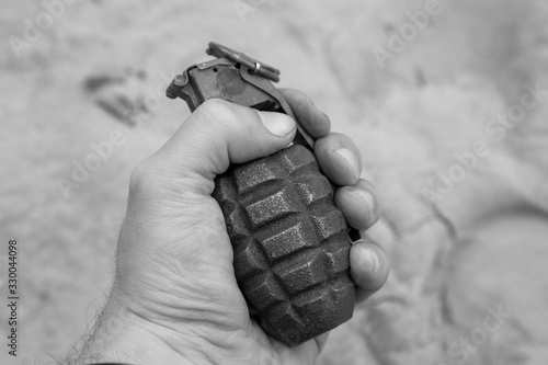 Slika na platnu black and white photo of a military grenade in hand