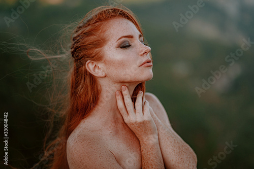 Fotografie beautiful furious scandinavian warrior ginger woman in grey dress