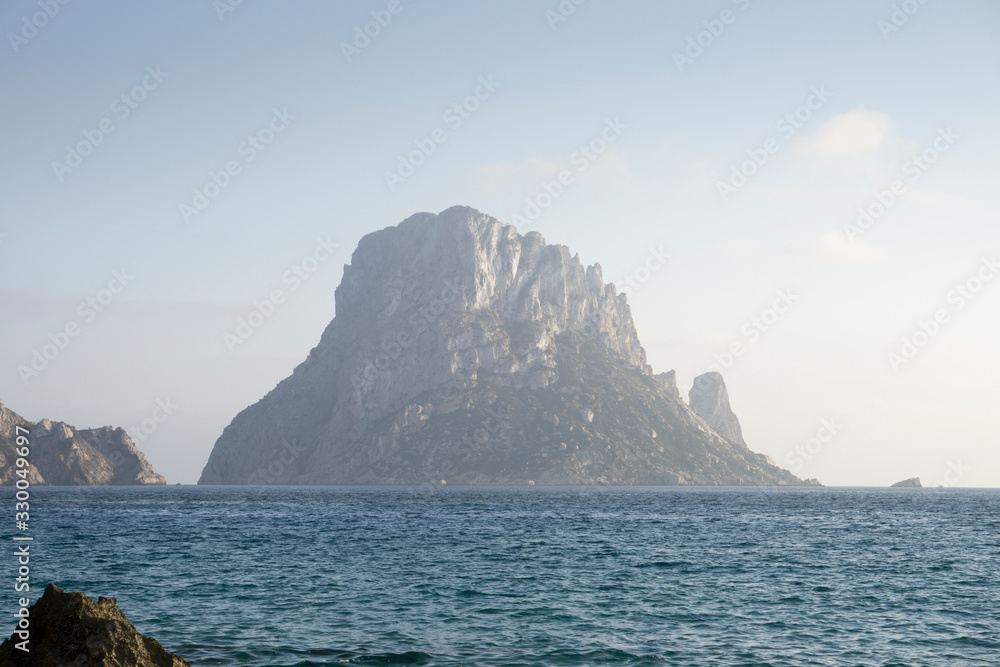 Naklejka premium Sunset from Cala D Hort with Es Vedra island Ibiza Balearic islands Spain on June 20, 2019