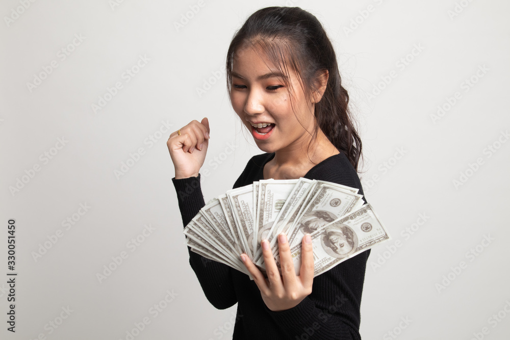 Portrait of young asian woman showing bunch of money banknotes. Portrait of young asian woman showing bunch of money banknotes.