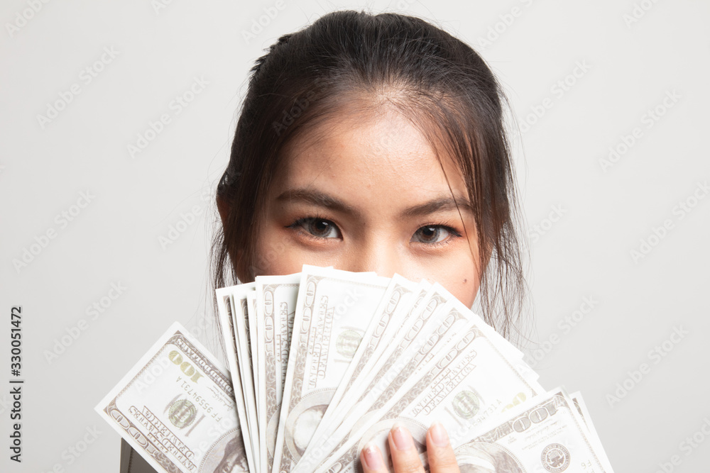 Portrait of young asian woman showing bunch of money banknotes. Portrait of young asian woman showing bunch of money banknotes.