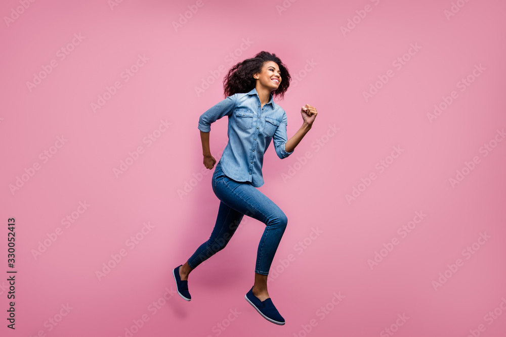 Full body profile side photo of active afro american youth girl jump run fast after spring black friday discounts wear casual style outfit isolated over pink color background Full body profile side photo of active afro american youth girl jump run fast after spring black friday discounts wear casual style outfit isolated over pink color background