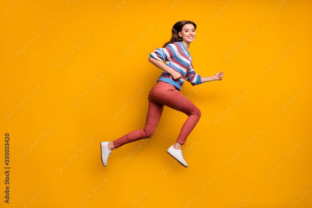 Full length profile side photo of cheerful girl jump run fast after spring discounts wear sweater sneakers isolated over shine color background