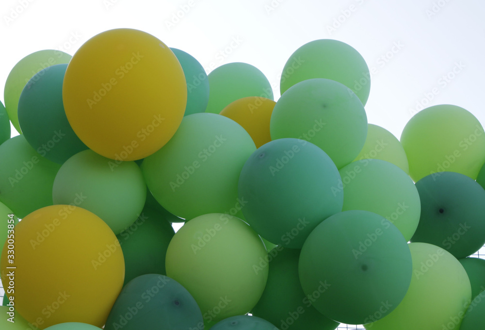 Green, light green and yellow balloons. A lot of balloons. Stock Photo