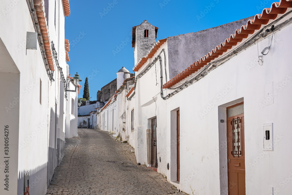 White houses on a narrow street in an ancient Portuguese town