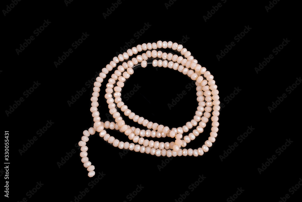 Natural stone beads on a black background isolated