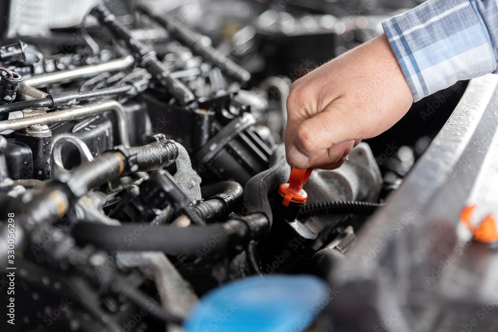 Checking oil in car engine. Checking oil in car engine.