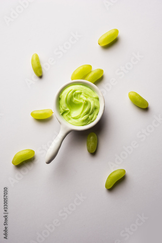 Green grapes, yogurt and honey mix face mask or cream for skin dark spot removal treatment, created using Angoor extract, curd and honey. selective focus photo