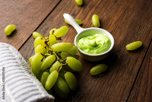 Green grapes, yogurt and honey mix face mask or cream for skin dark spot removal treatment, created using Angoor extract, curd and honey. selective focus photo