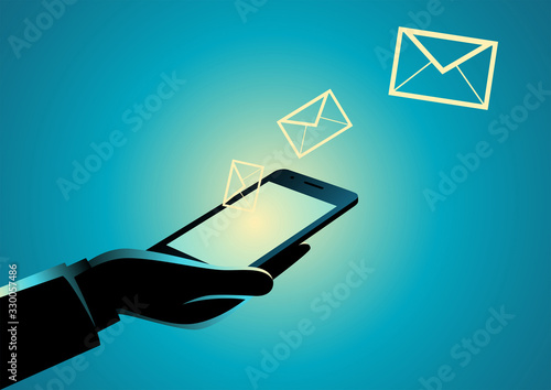 Hand holding cellular phone with email icons