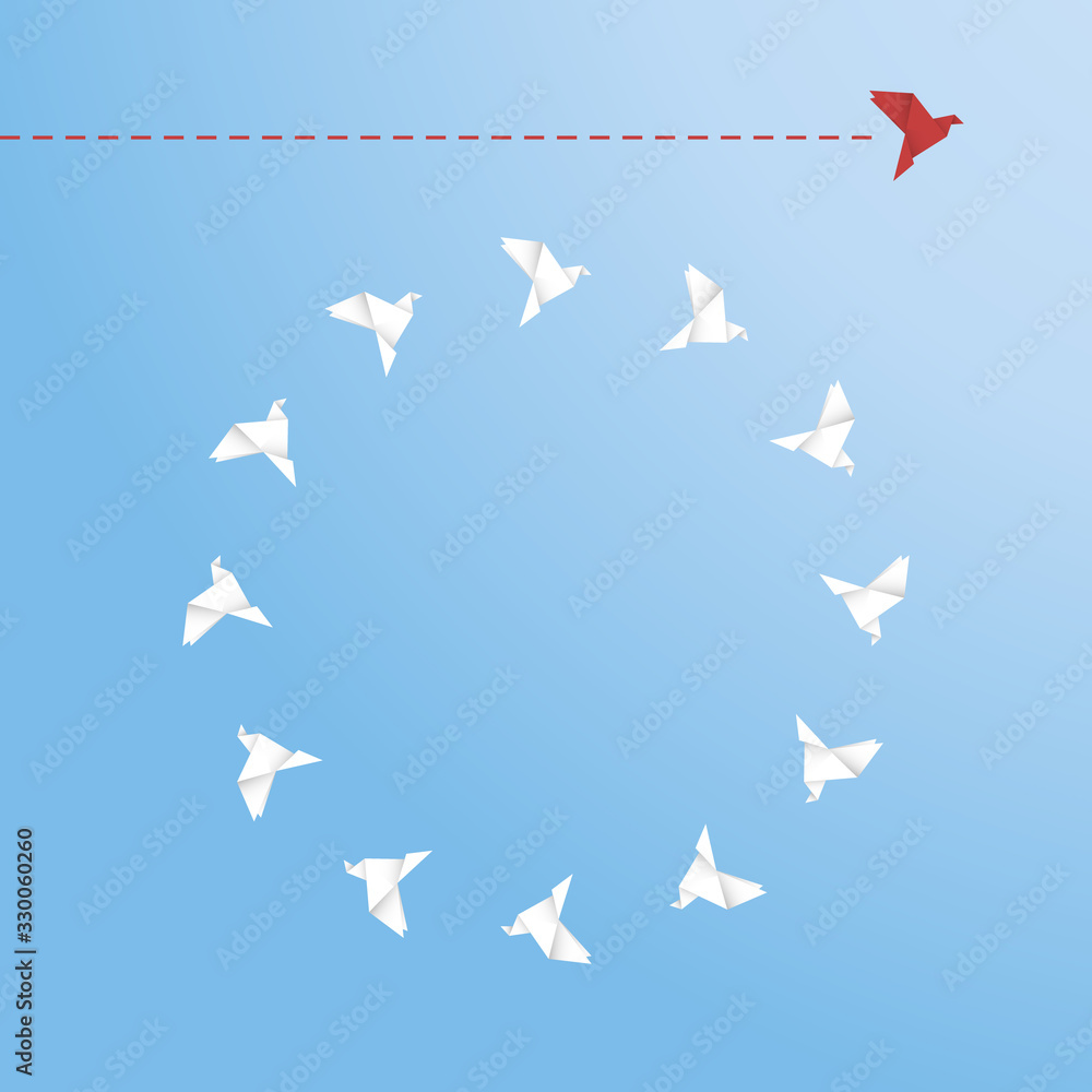 Think differently concept. Be different. Red bird changing direction. New idea, change, trend, courage, creative solution, innovation and unique way concept Think differently concept. Be different. Red bird changing direction. New idea, change, trend, courage, creative solution, innovation and unique way concept