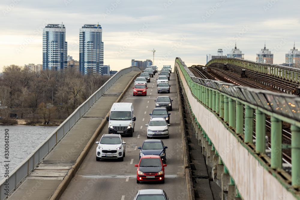 Cars in the morning traffic jam ride on the metro bridge in Kiev.