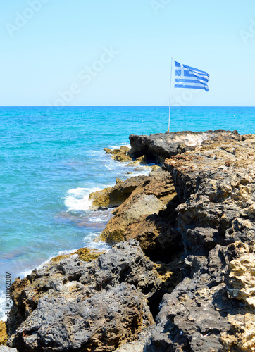 Kato Gouves coast in Crete flying the national flag photo