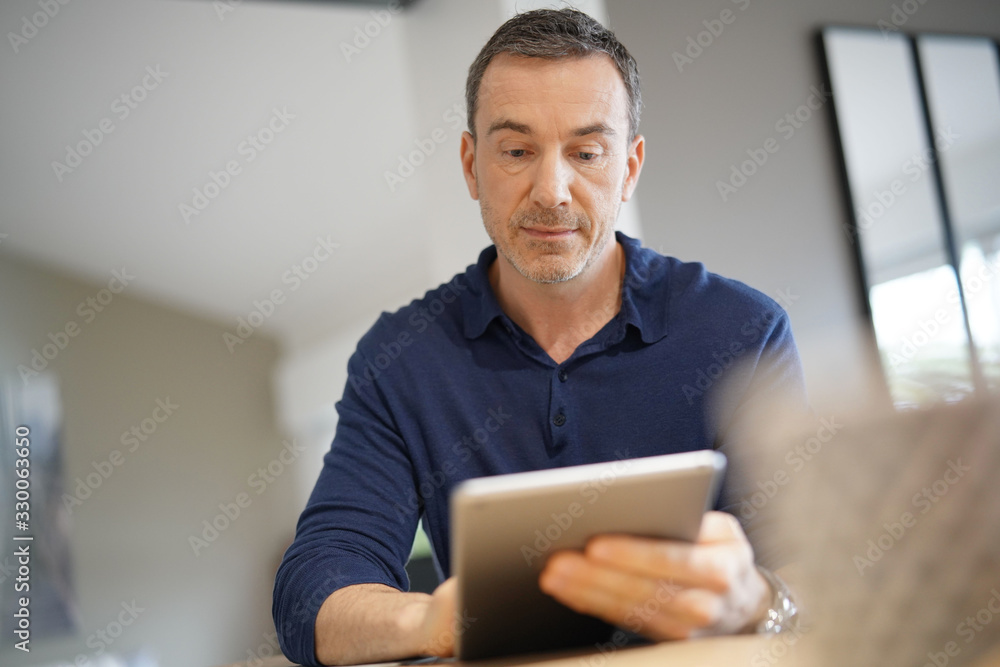 Portrait of middle-aged man connected on digital tablet Portrait of middle-aged man connected on digital tablet