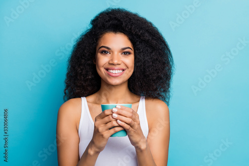 Close-up portrait of her she nice attractive lovely pretty cute cheerful cheery glad wavy-haired girl drinking sweet hot cacao isolated on bright vivid shine vibrant blue color background