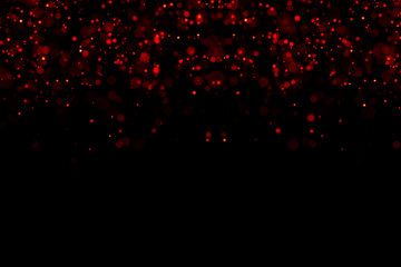abstract waterfalls of red glitter sparkle bubbles particles bokeh on black background,christmas and happy new year holiday