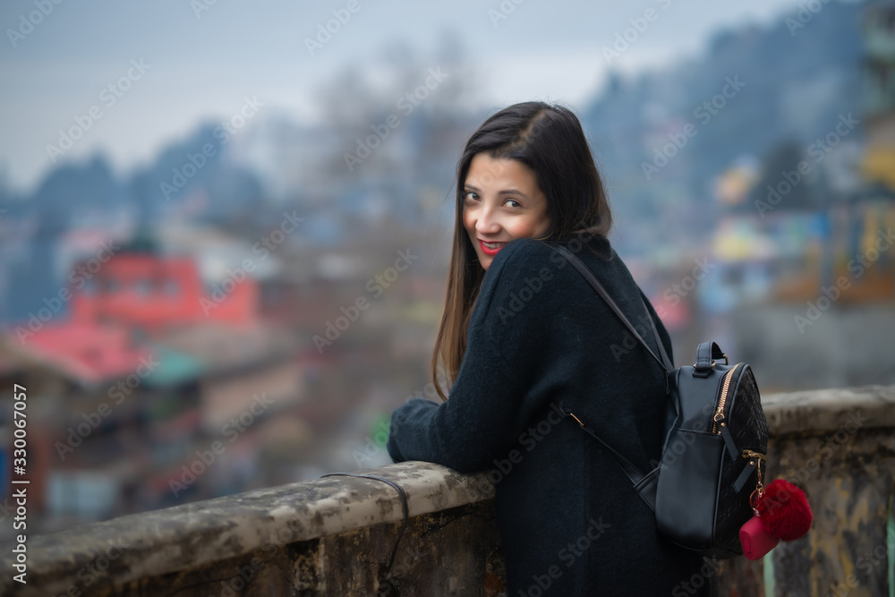 Fototapeta premium The young woman in black shirt is standing thinking