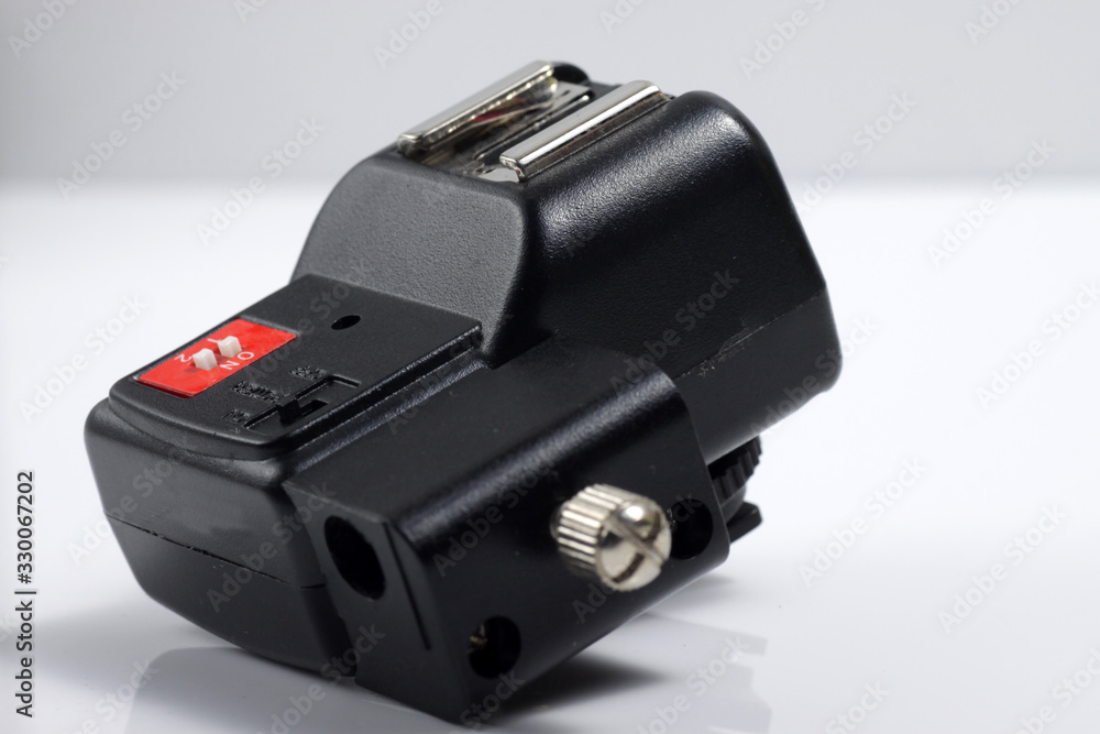 Close up shot of black camera flash trigger isolated on white background Close up shot of black camera flash trigger isolated on white background