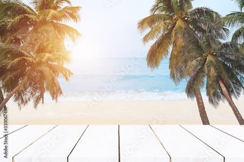beach background top of wood table with blurred sea and coconut tree background