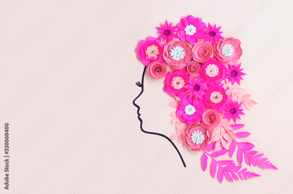 Silhouette of female head with paper flowers