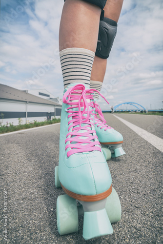 Woman rollerskater wearing knee protector pads photo