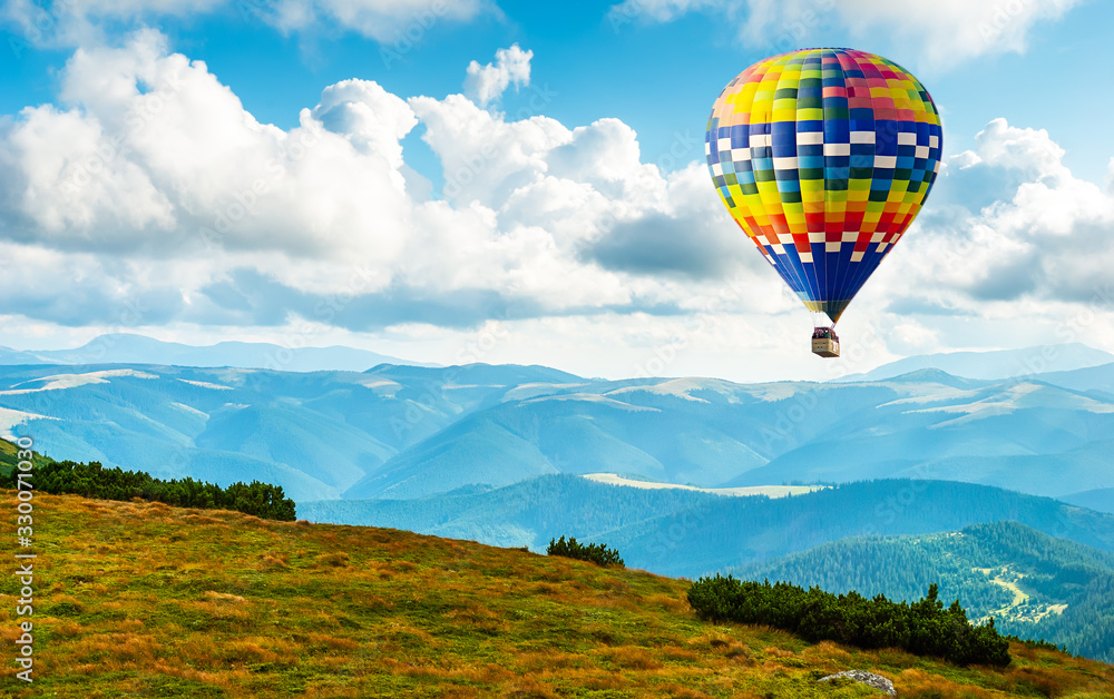 Naklejka premium Amazing view of mountains with colorful hot air balloon. Travel concept. Artistic picture. Beauty world.