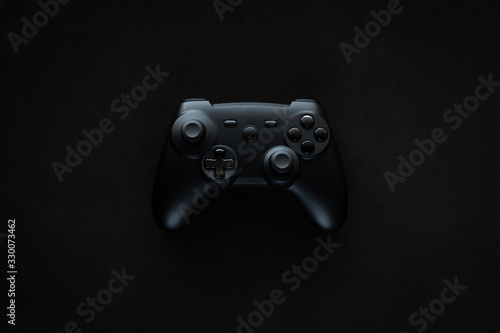 Stock photo of a gamepad on a textured black background